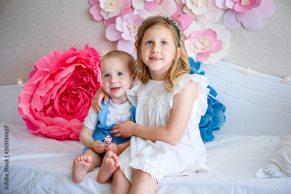A sweet girl and her brother at home A sweet girl and her brother at home