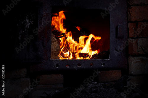 Old, cast iron oven with flame fire