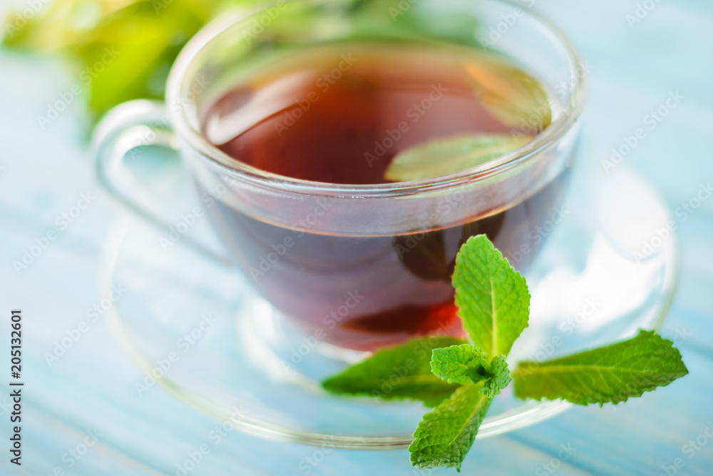 tea in a glass cup and fresh mint leaves tea in a glass cup and fresh mint leaves
