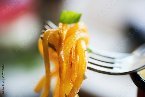 Pumpkin noodle on fork.