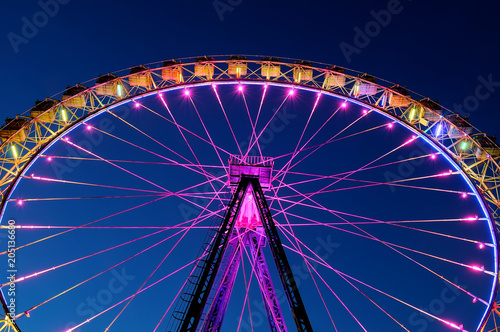 Big ferris wheel with festive colorful illumination