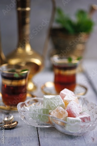 traditional oriental dessert Turkish Delight on an old table  with mint tea