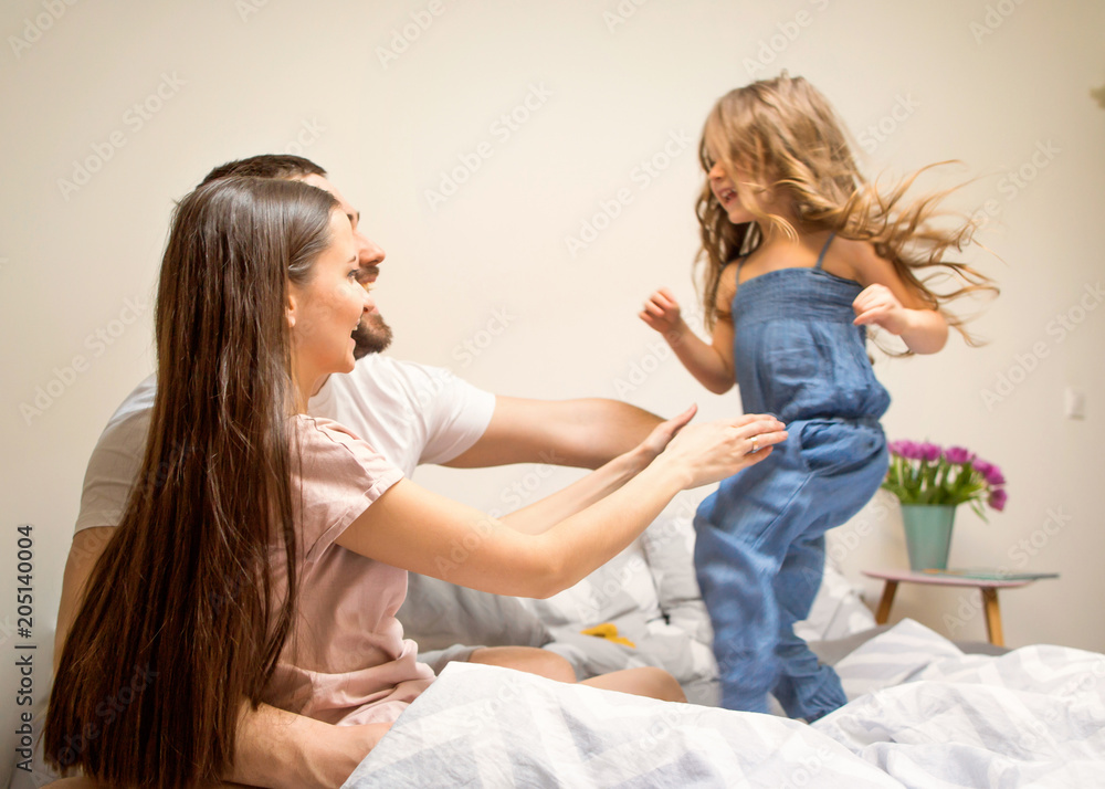 happy family playing with her daughter at home happy family playing with her daughter at home