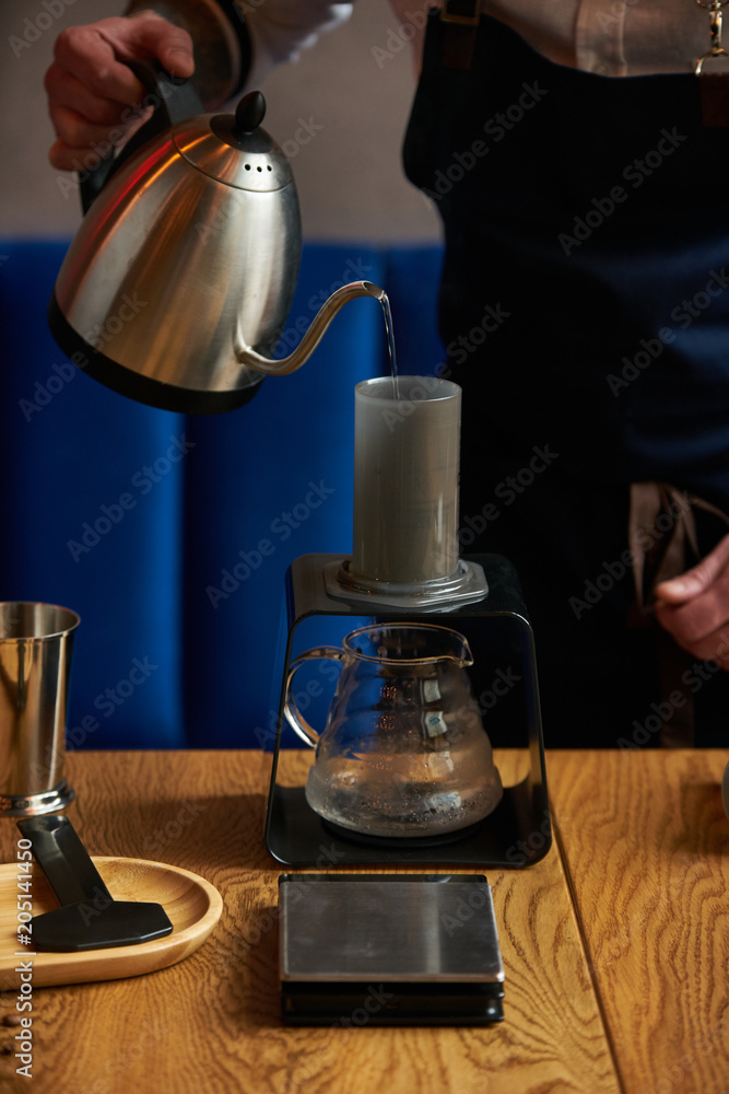 Barista prepare coffee at bar counter using different glassware and utensil, close-up Barista prepare coffee at bar counter using different glassware and utensil, close-up