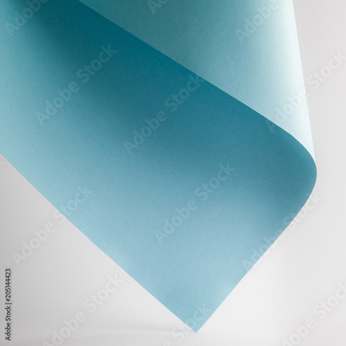 colored blue paper sheet on grey background