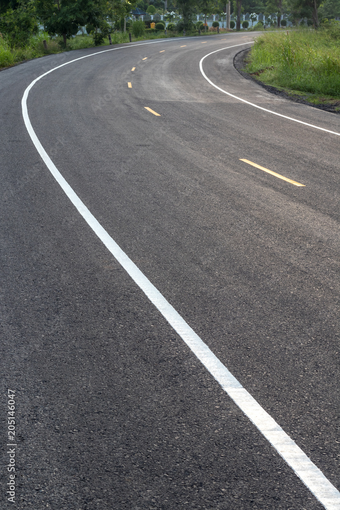 Curved road surface, which is new paved.