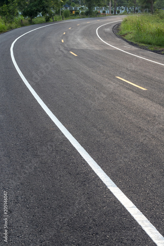 Curved road surface, which is new paved.