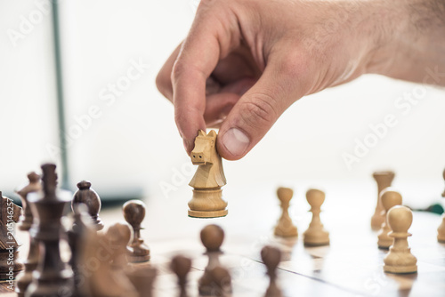 cropped shot of person playing chess, selective focus