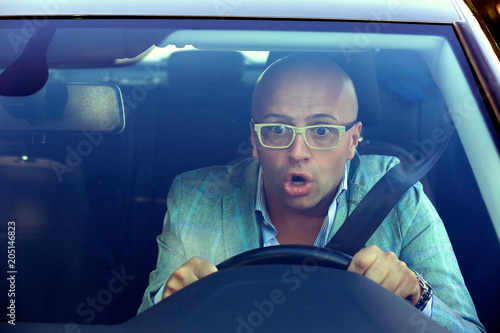 Shocked man driving car having accident