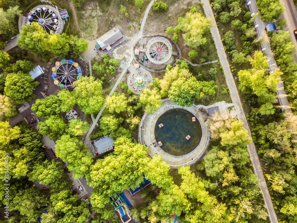 aerial view of amusement park with many trees on a summer day