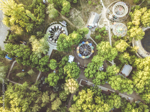 aerial view of amusement park with many trees on a summer day