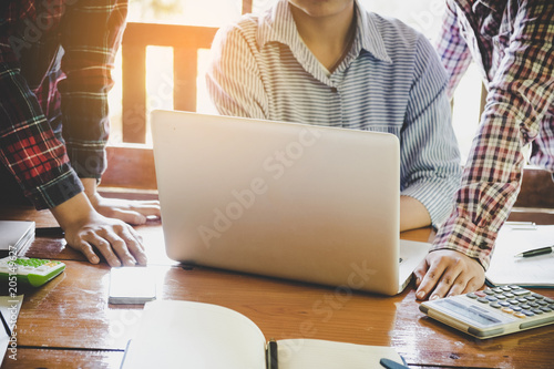 Successful businessteam of three sitting in office and planning work