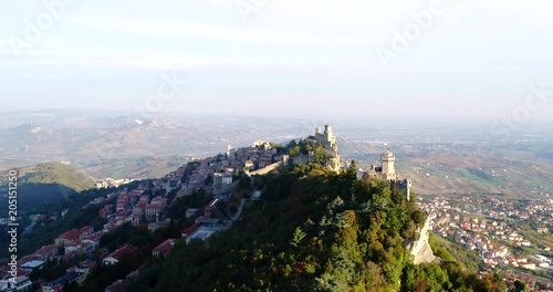 Mountain castles, C4k aerial view towards Cesta, Guaita and Montale fortress, on a sunny autumn day, in San Marino city