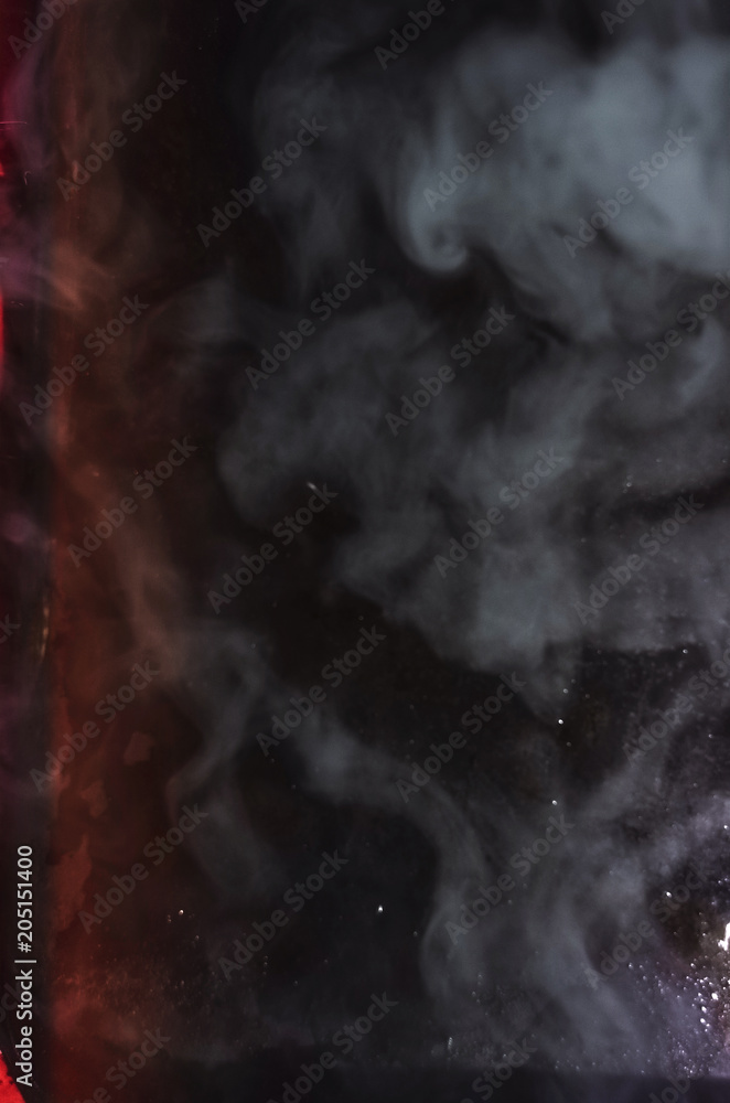 smoke on a black background. red rays. texture smoke on a black background. red rays. texture