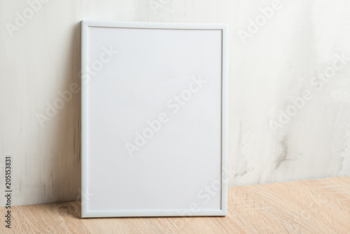 Empty white frame on the wall background. The concept of design and font inscriptions and image placement