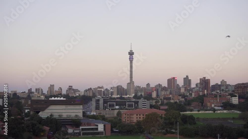 Johannesburg, South Africa, 26 April 2018 - A time-lapse of the sunset over Johannesburg's Hillbrow, featuring Hillbrow tower and Ponte City tower. photo