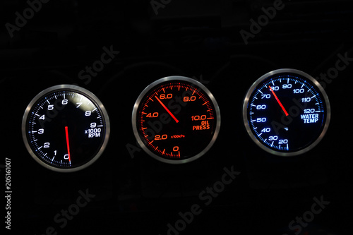 Modern car instrument dashboard panel in night time © foto76