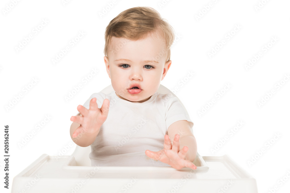 little boy sitting in highchair isolated on white background little boy sitting in highchair isolated on white background