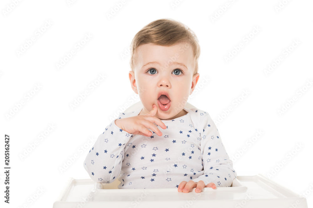 adorable little boy sitting in highchair isolated on white background adorable little boy sitting in highchair isolated on white background