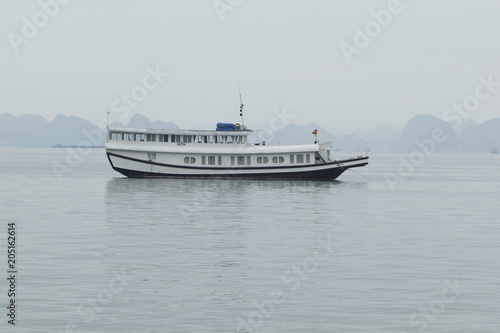 Tourist ferry boat in Halong Bay, the Unesco world heritage site in Vietnem. © binhdd