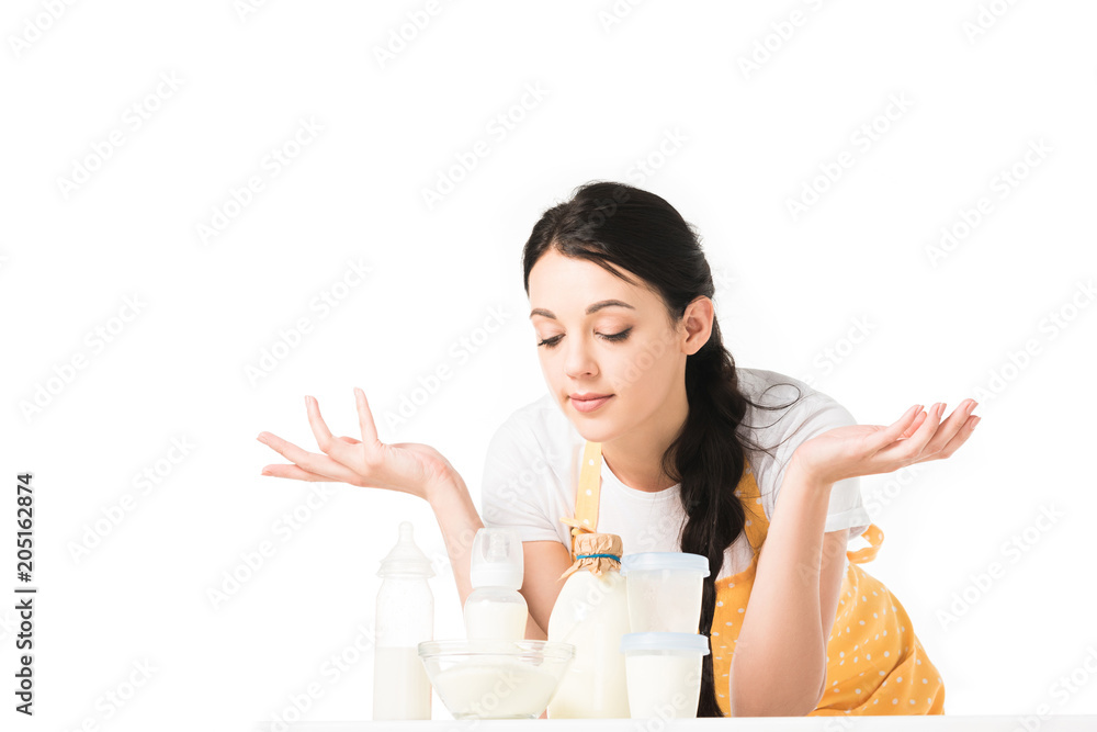 woman in apron with wide arms standing at table with children food and milk isolated on white background woman in apron with wide arms standing at table with children food and milk isolated on white background