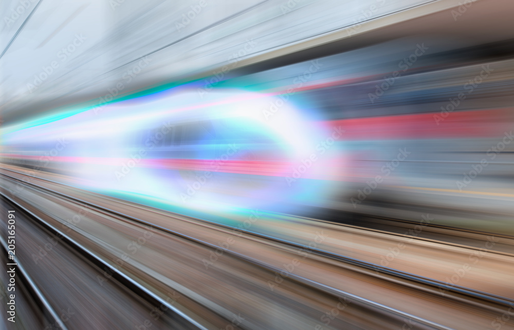 White high speed train runs on rail tracks . Train in motion. White high speed train runs on rail tracks . Train in motion.
