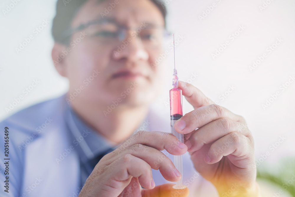 Close up of doctor prepare the syringe to make injection Close up of doctor prepare the syringe to make injection