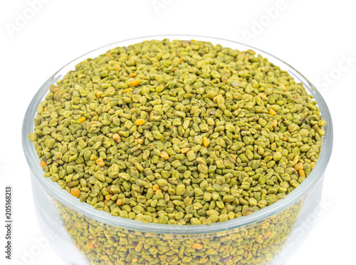 Green Fenugreek Seeds Also Know as Methi Seeds in India isolated on White Background