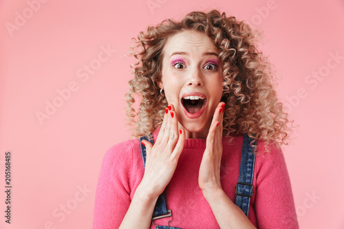 Close up portrait of excited young girl with curly hair