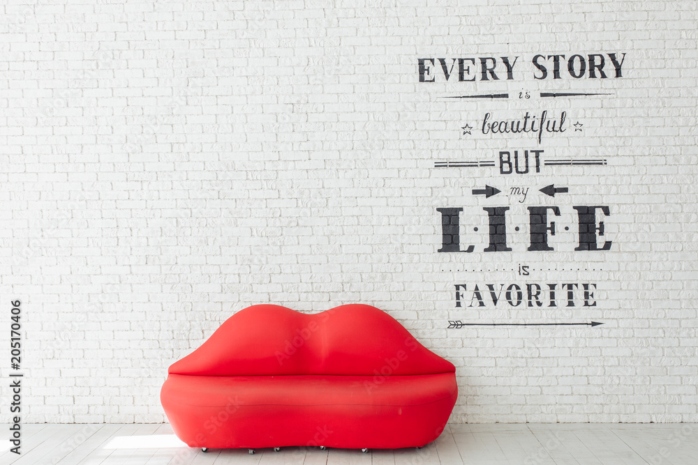 Red sofa lips shape on white brick wall background. Minimalism concept