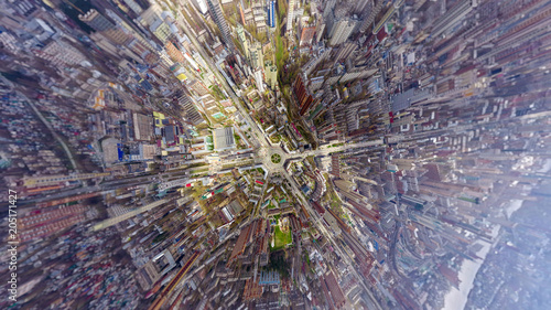 Helicopter drone shot. Aerial photography of a modern city over an area, a large crossroads, high-rise buildings, a park and roads. Panoramic city shot from above