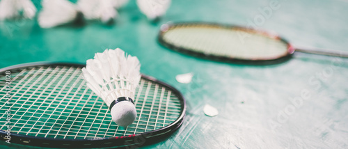 Badminton ball  shuttlecock  and racket on court floor