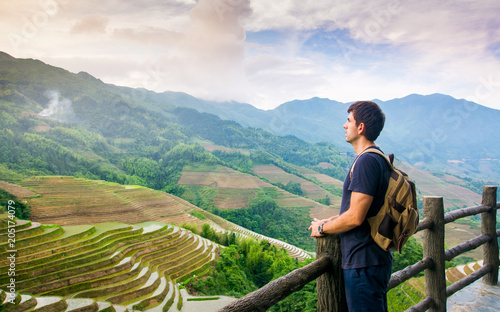 Photography Man enjoying stunning Asian rice terrace scenery