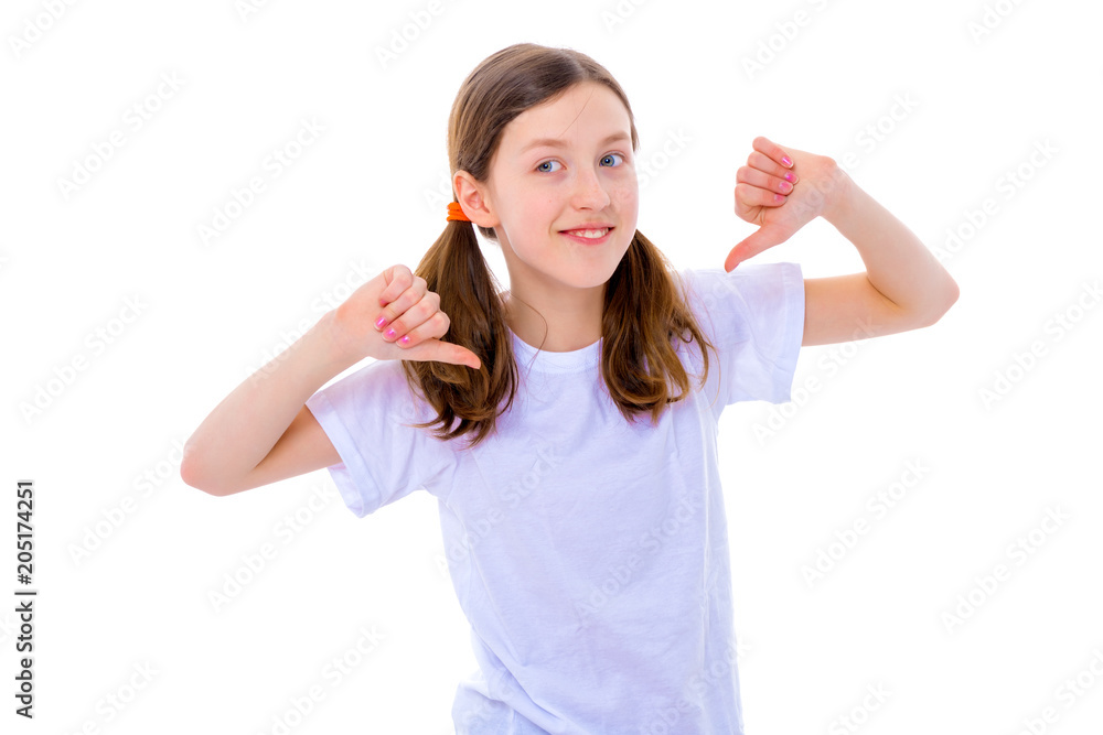 Little school girl pointing to her empty white t-shirt. Little school girl pointing to her empty white t-shirt.