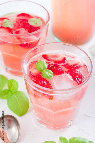 Fresh cool summer drink with strawberries and green basil, selective focus