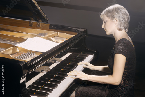 Piano player. Pianist woman playing piano