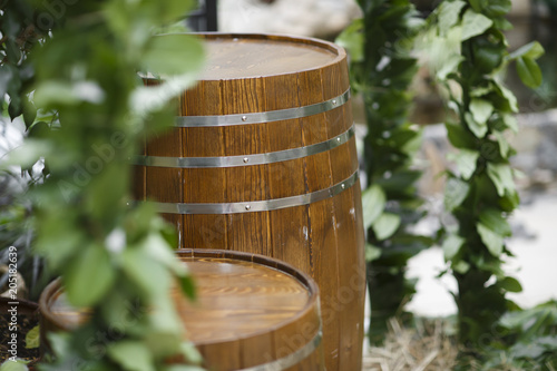 wooden barrel on the background of greenery