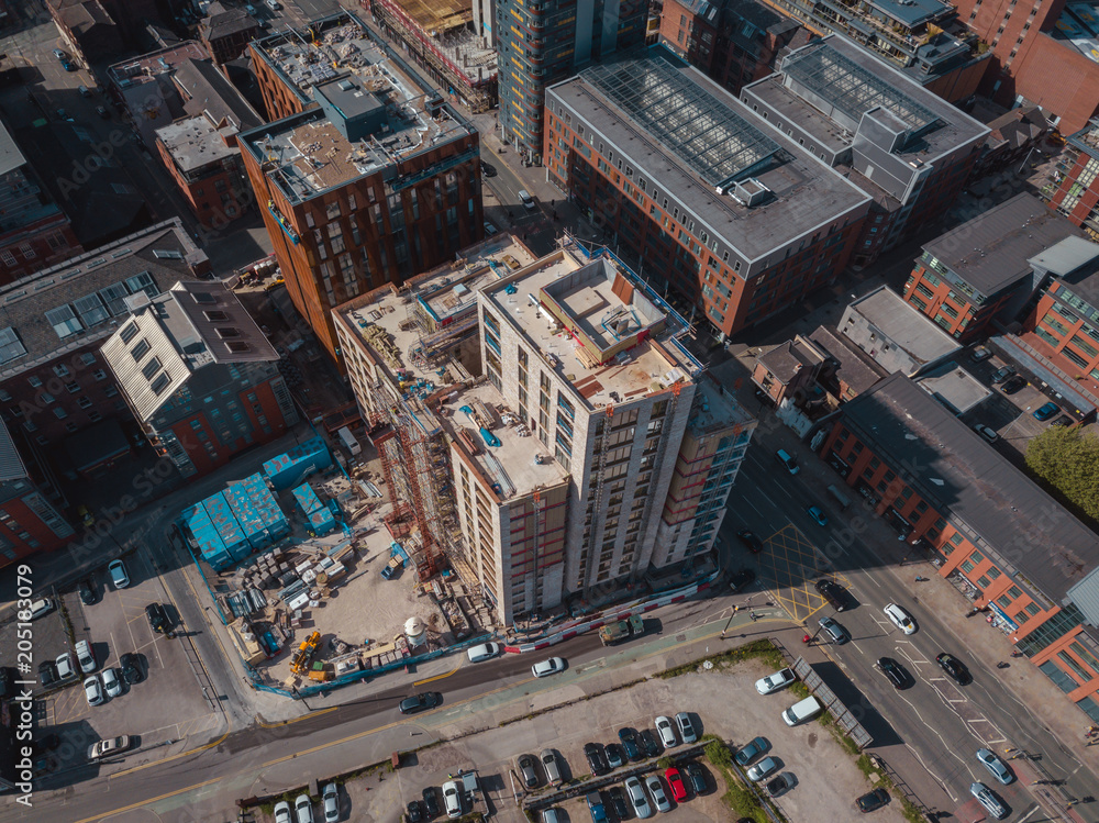 Aerial city centre drone above buildings british manchester skyline summer blue sky ancoats northern quarter