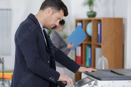 businessman using photocopy machine in office