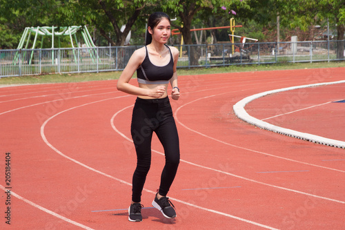 Woman run in track stadium 