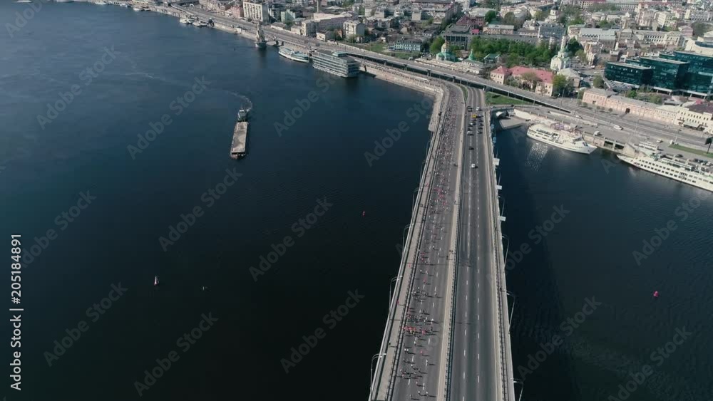 4K Aerial drone fooage. Marathon running on the bridge. Wide shot. 4K Aerial drone fooage. Marathon running on the bridge. Wide shot.