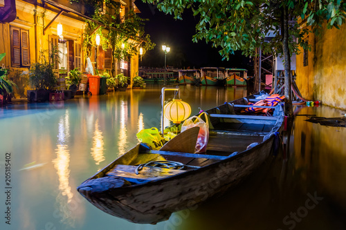 Hoi An, Vietnam. Street view with traditional boats on a background of ancient town