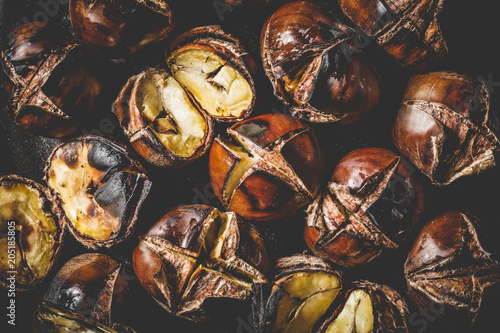 Close up of Roasted chestnuts in iron grilling pan.