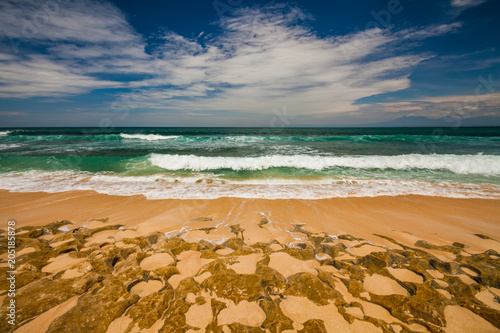 Bali seascape with huge waves at beautiful hidden white sand beach. photo