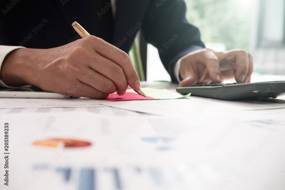 Asian business man analyze and discuss the situation on the marketing data online and calculate about cost in the meeting room. Business finances and accounting Asian business man analyze and discuss the situation on the marketing data online and calculate about cost in the meeting room. Business finances and accounting