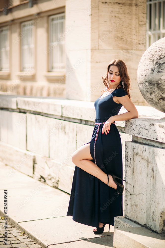 A beautiful girl in a dress is walking around the city A beautiful girl in a dress is walking around the city