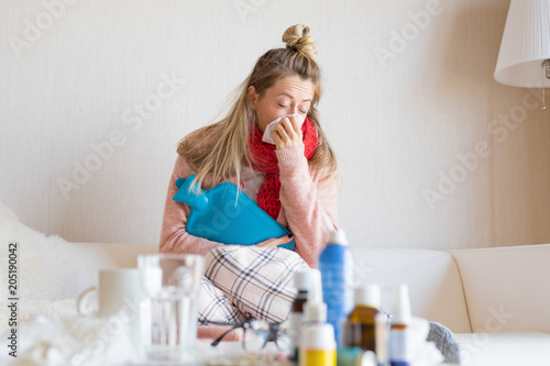 Sick woman with hot water bottle
