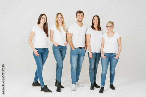 Casual relaxed group of five friends in blue jeans