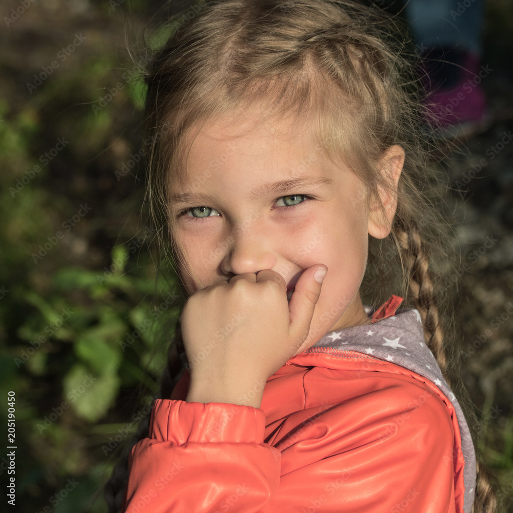 The little girl smiles and looks forward. Tinted, instagram, happiness, joy, childhood. The little girl smiles and looks forward. Tinted, instagram, happiness, joy, childhood.