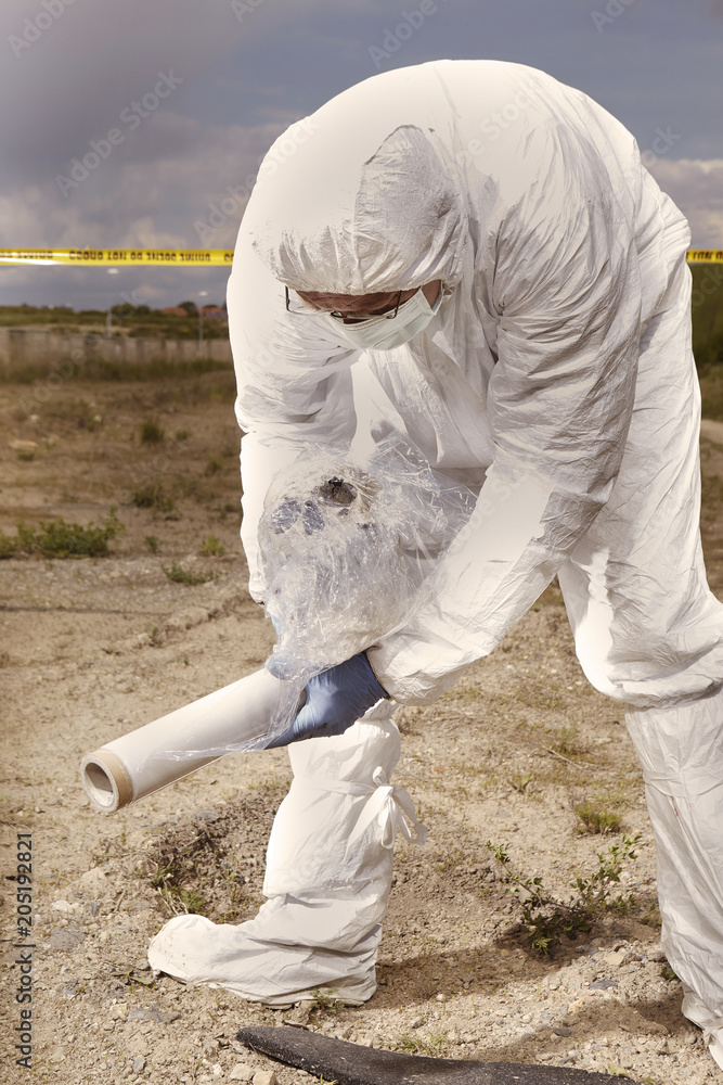 Police technician packing human skull found on plain construction yard during work